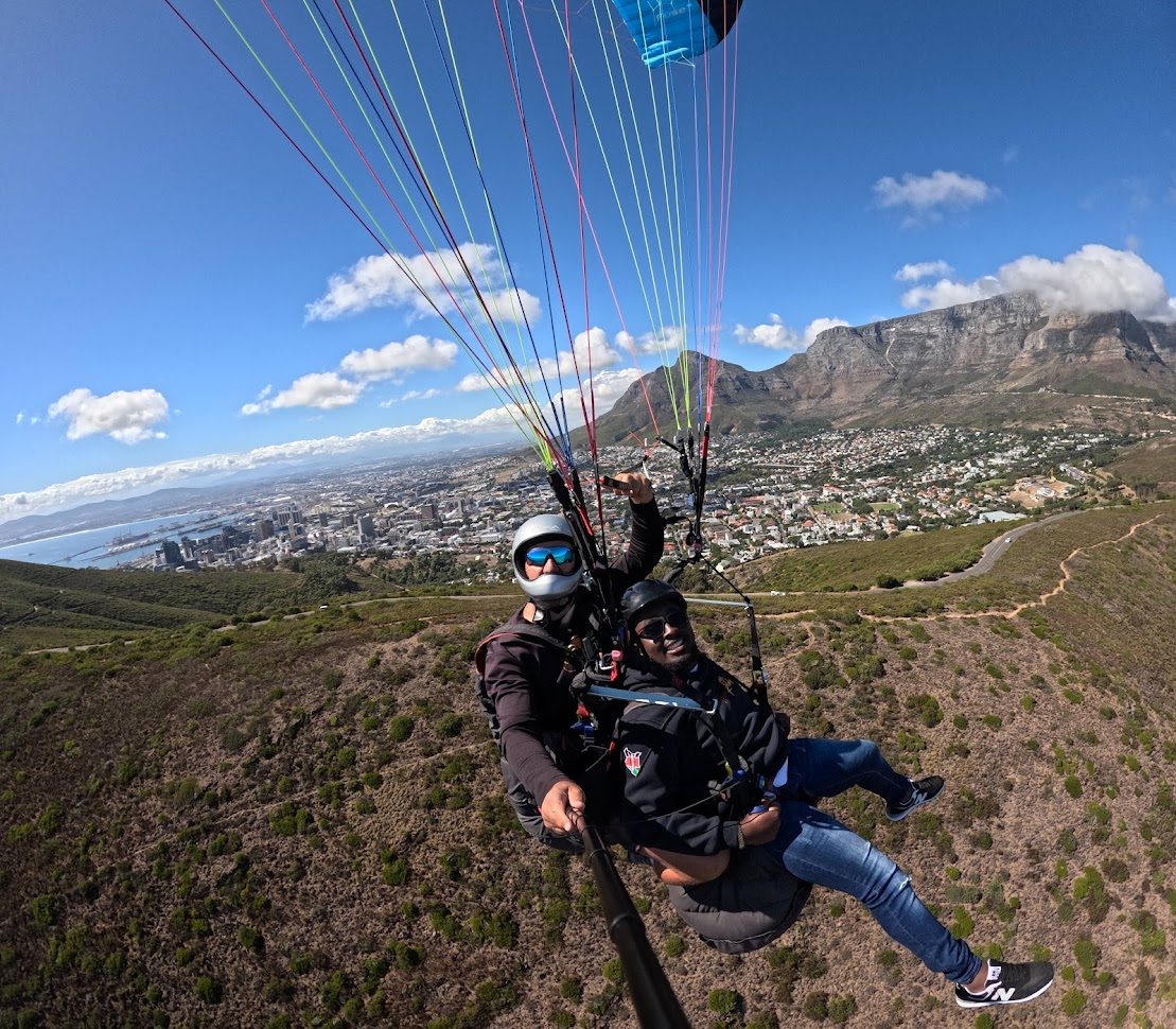 Tandem paragliding above Cape Town with Table Mountain behind